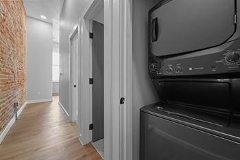 A black oven in a kitchen next to a white door.
